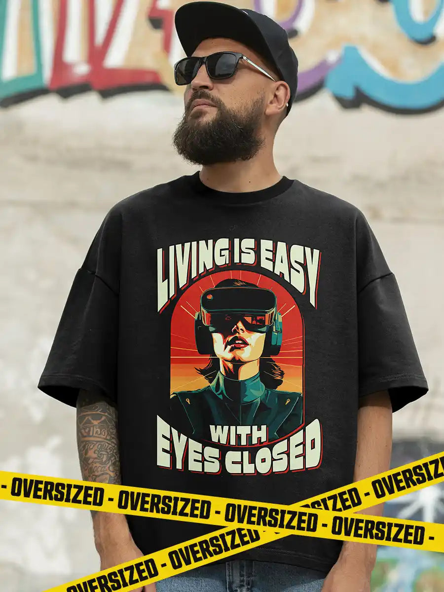 Man wearing Living is EASY with eyes Closed - Black  Oversized T-Shirt