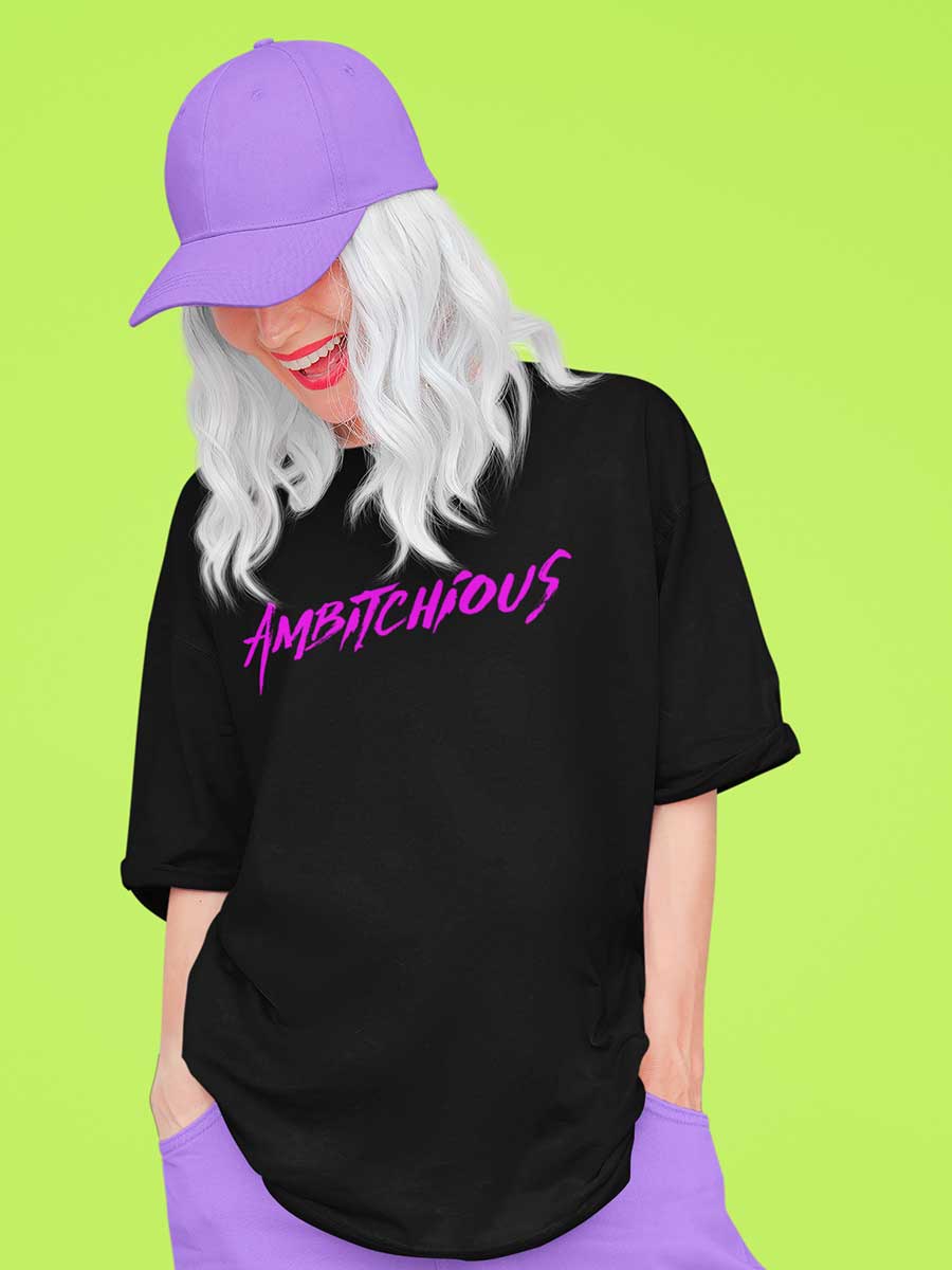 Woman wearing Black Oversized Cotton Tshirt with text "Ambitchious " in pink